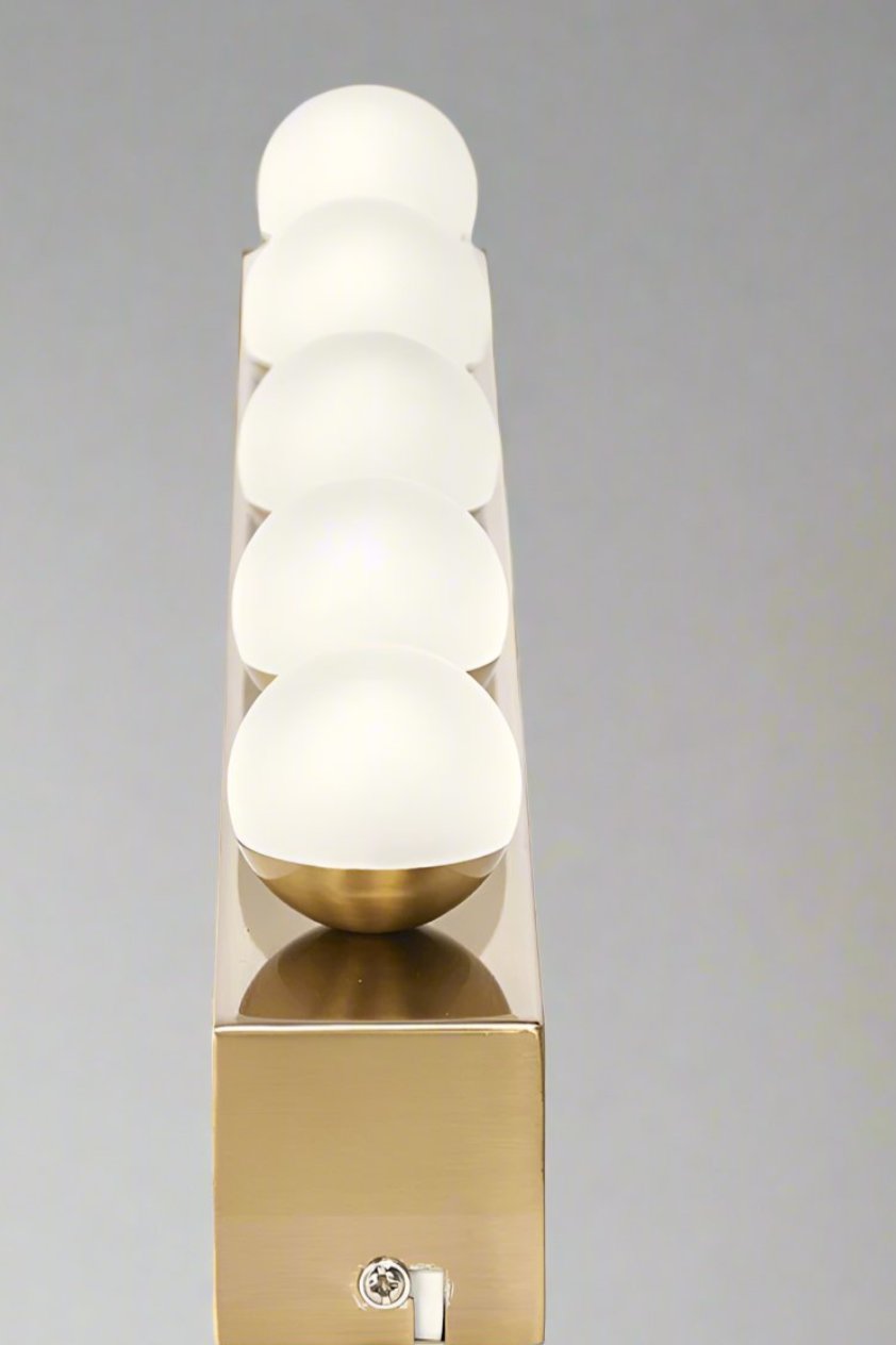 Tilted view of the Brushed brass vanity stip light with 5 LED bulbs 