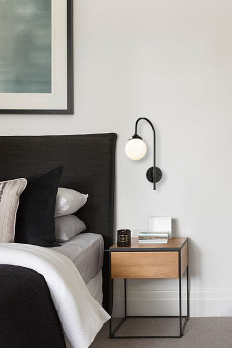 Glass ball shepherds hook in black as a bedside light.