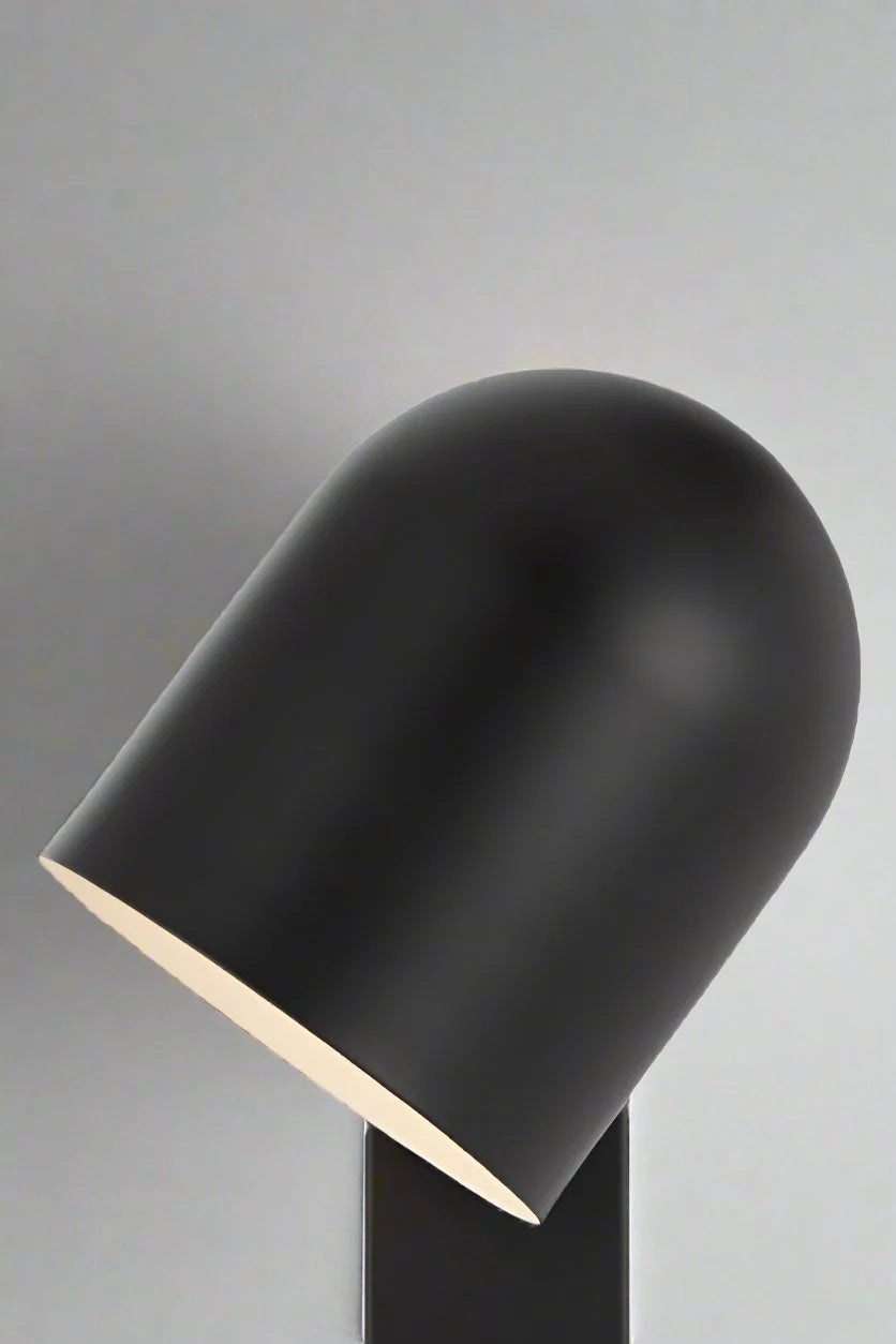 Close up of a Black touch wall light with swival shade. 