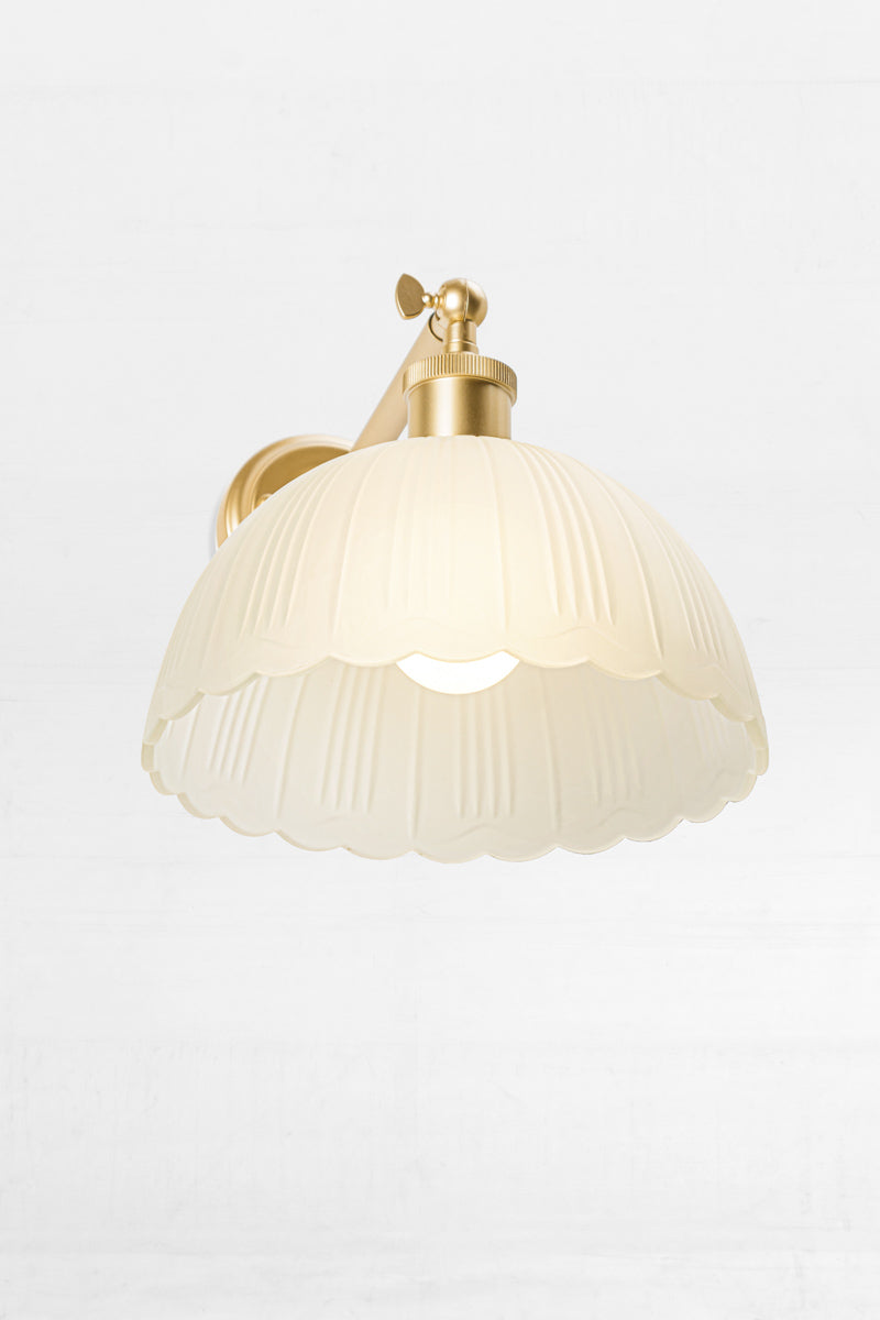 gold short arm sconce with dome frost glass shade and scalloped edging