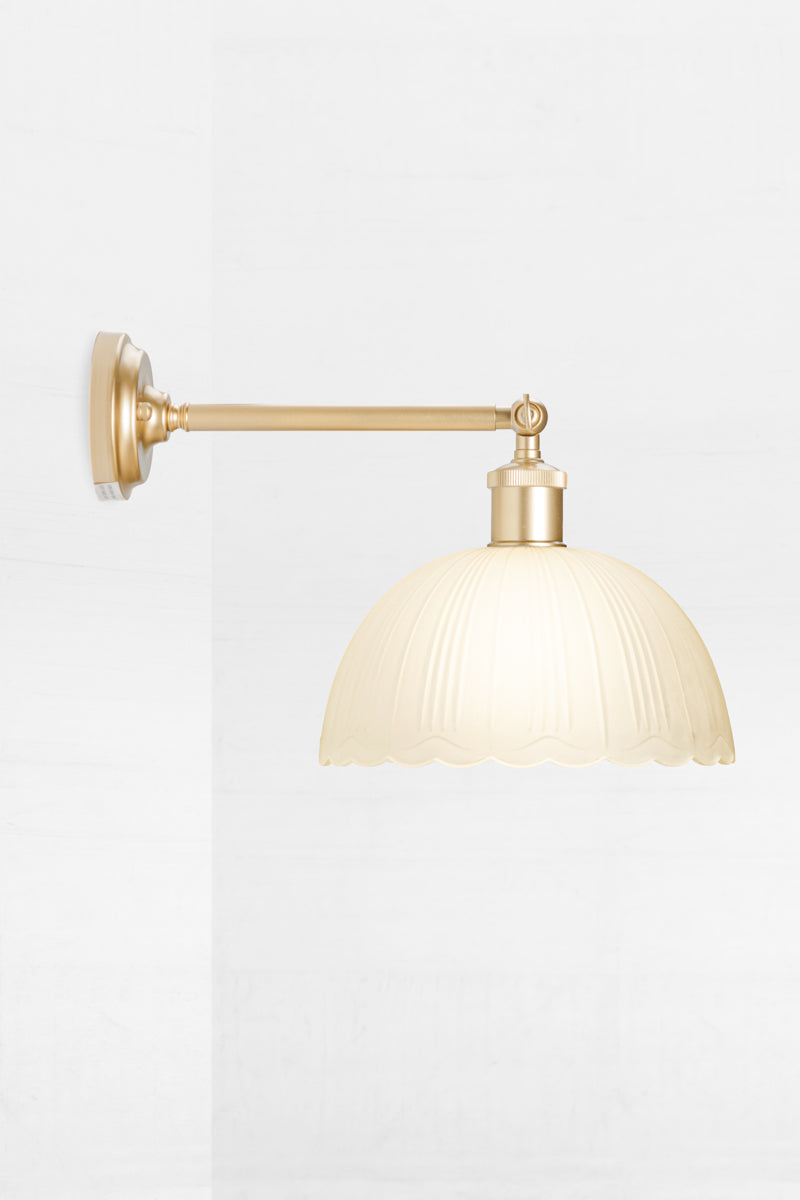 gold long arm sconce with dome frost glass shade and scalloped edging