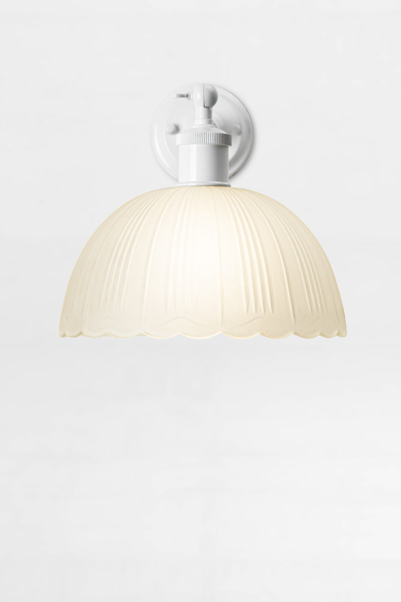 white short arm sconce with dome frost glass shade and scalloped edging