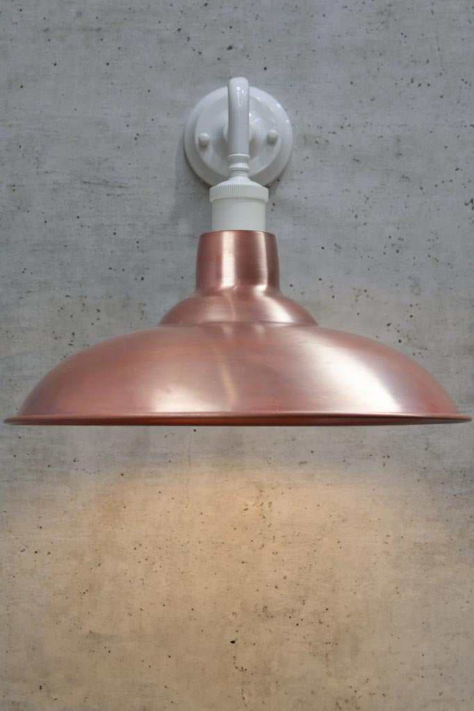 Front view of a white 90 degree wall sconce with a solid copper shade.