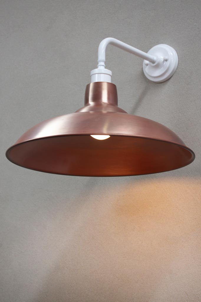 White 90 degree wall sconce with a solid copper shade.