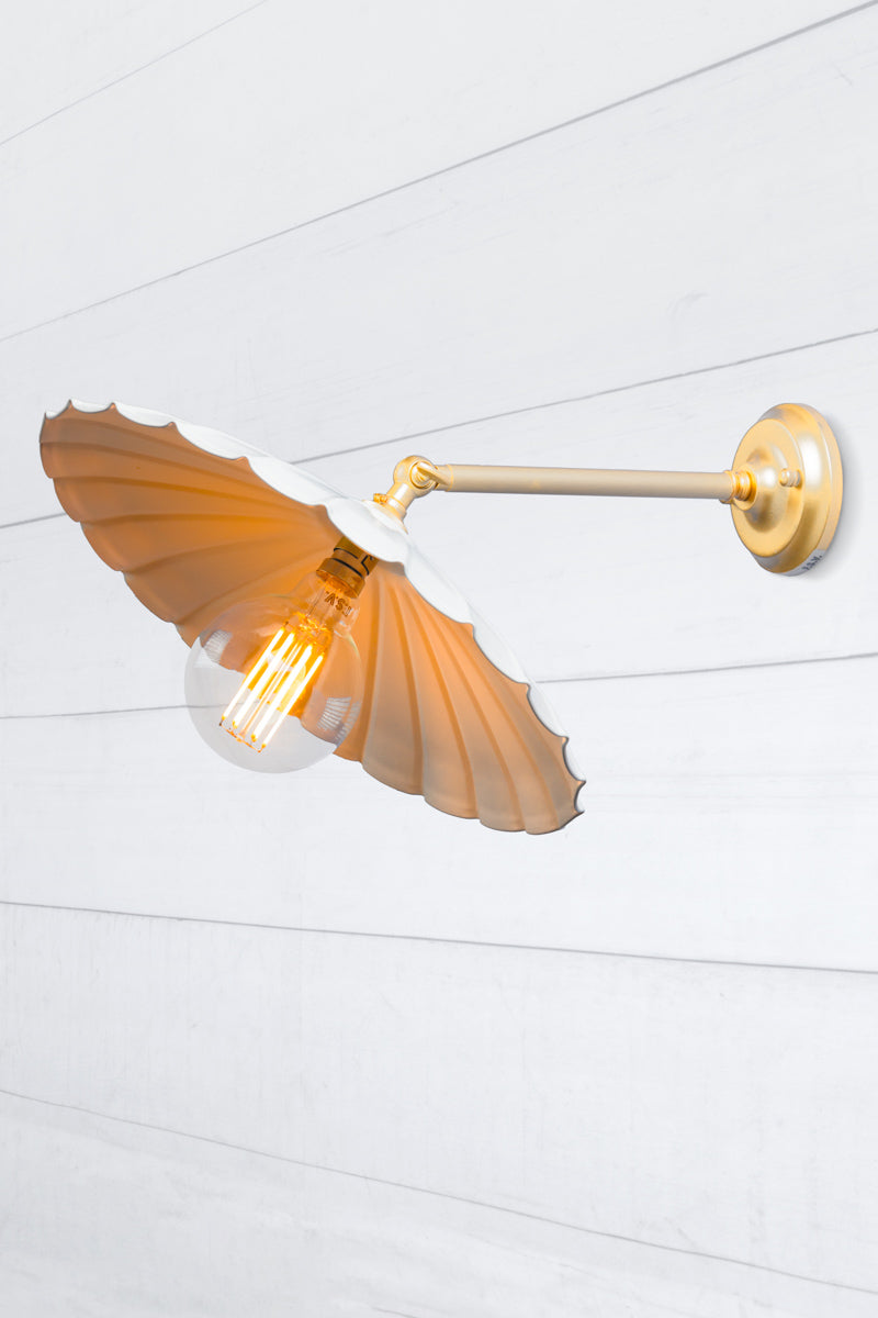 Large white umbrella shade on a gold/brass wall sconce. 