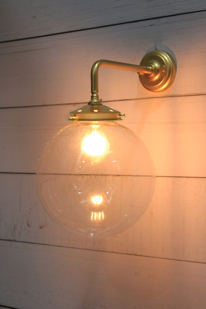 Medium Clear glass ball shade on a Gold/Brass 90 degree wall sconce