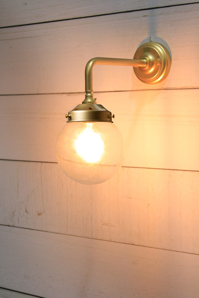 Small Clear glass ball shade on a Gold/Brass 90 degree wall sconce