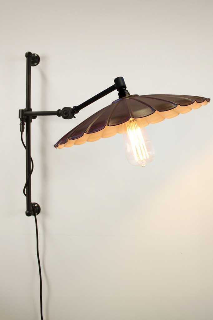 black swing arm with large rust umbrella shade