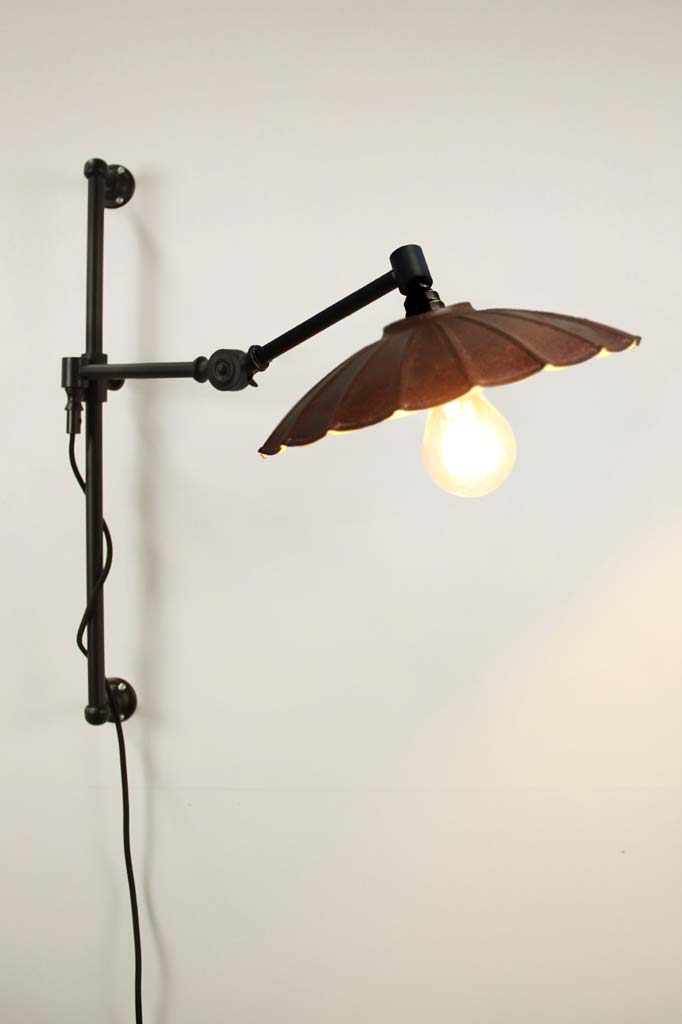 black swing arm with small rust umbrella shade