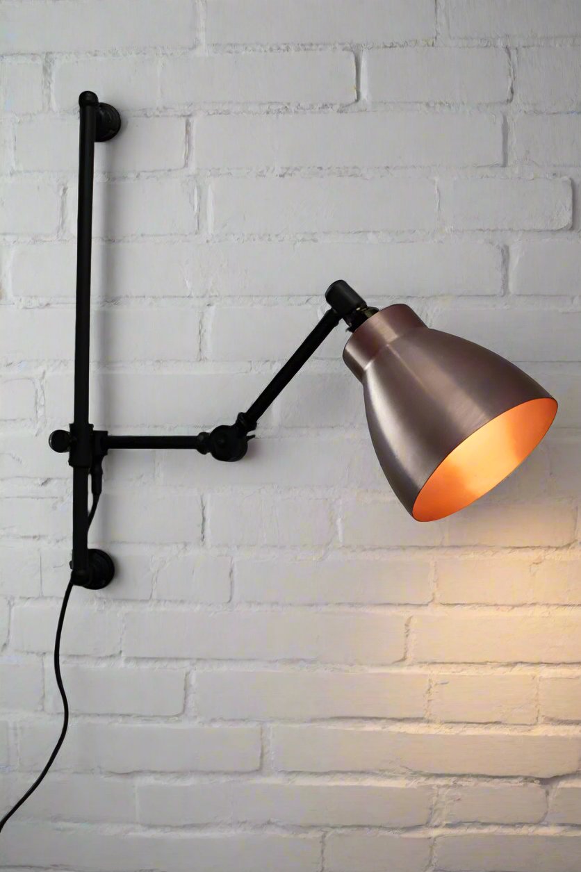 Copper cellar shade on a black swing arm with wall plug.