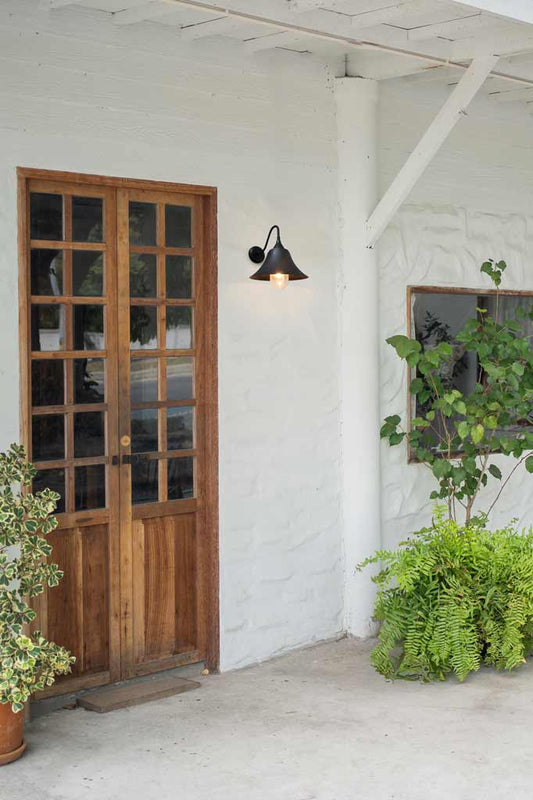 Vintage black wall light on the front door porch