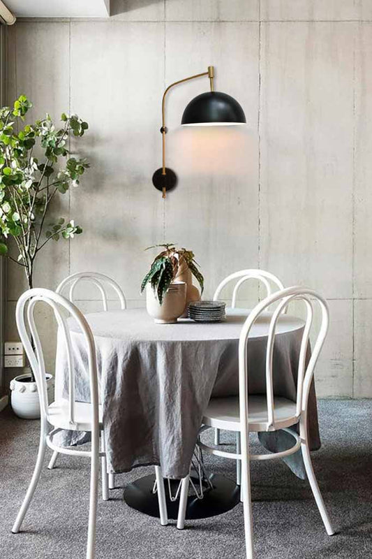 Dome wing wall lamp next to a dining table