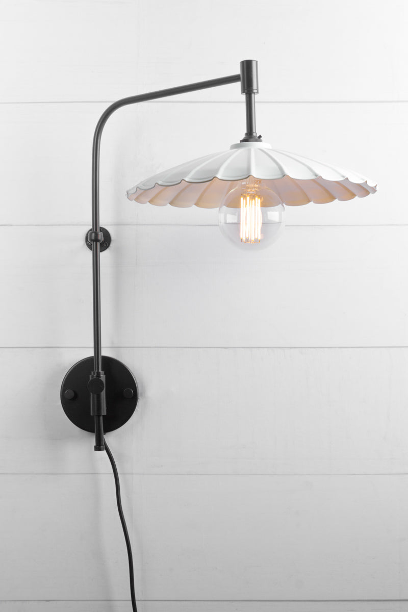 Large white umbrella shade, on a black wall arm with switch