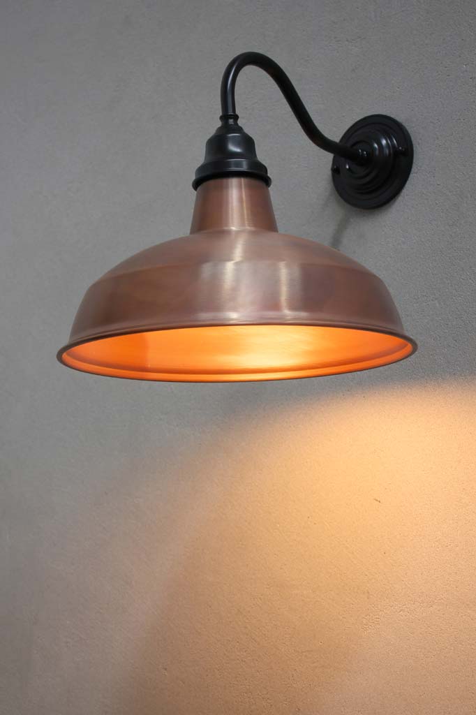 Warehouse Gooseneck Exterior Light with an black gooseneck arm and copper shade. 