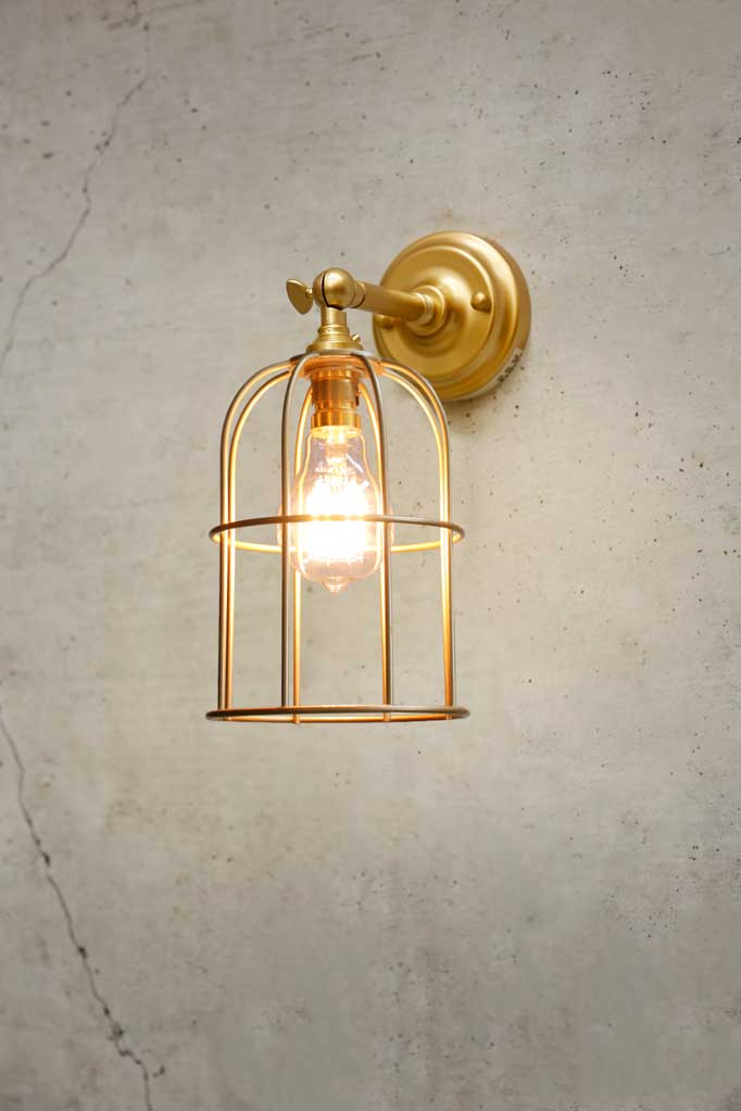 Cage Wall Light with short gold/brass sconce and matching caged shade.