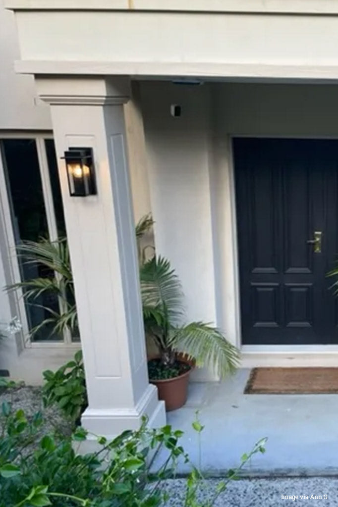 Black rectangular outdoor wall lantern  on entrance column of a home.