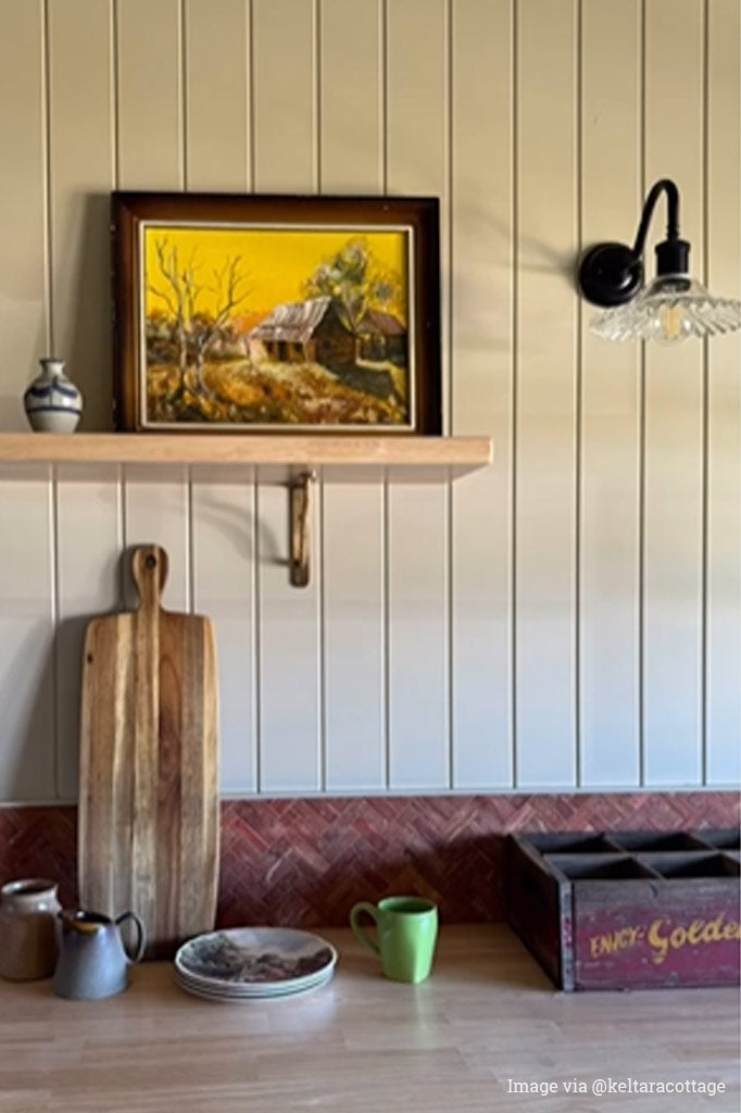 Charmont Glass Wall Light with a black gooseneck scone and clear shade installed in a farmhouse style kitchen