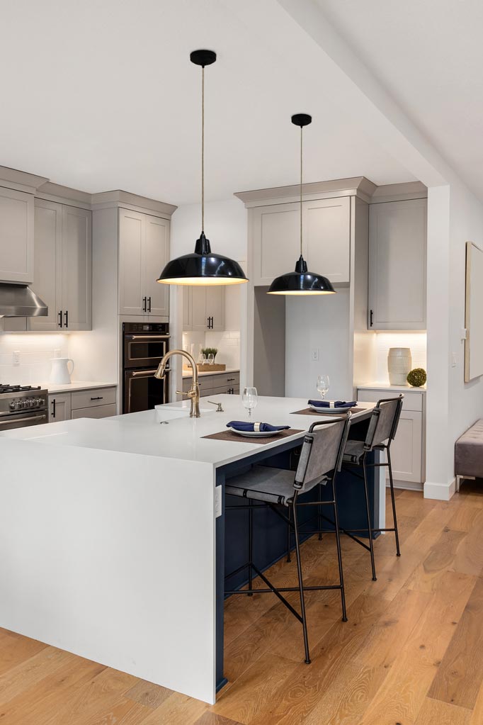 large black warehouse shades over kitchen island