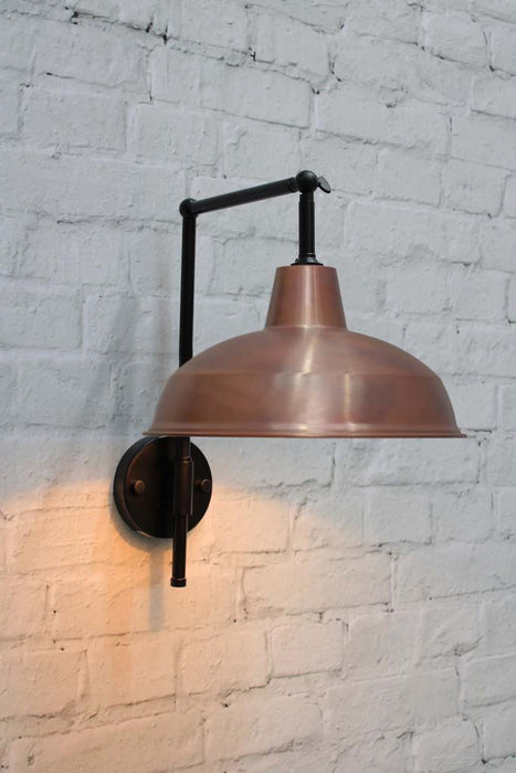 Warehouse Hook Swivel Arm Wall Light with a black arm and copper shade.