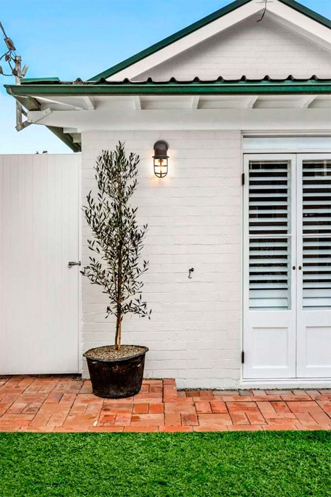 outdoor wall lamp in black finish in the backyard of a house