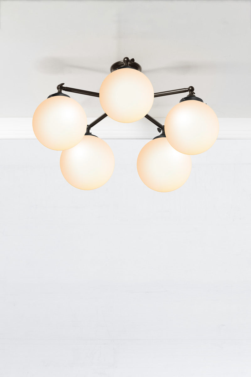 Small opal glass ball ceiling light with five black straight arm fixture. 