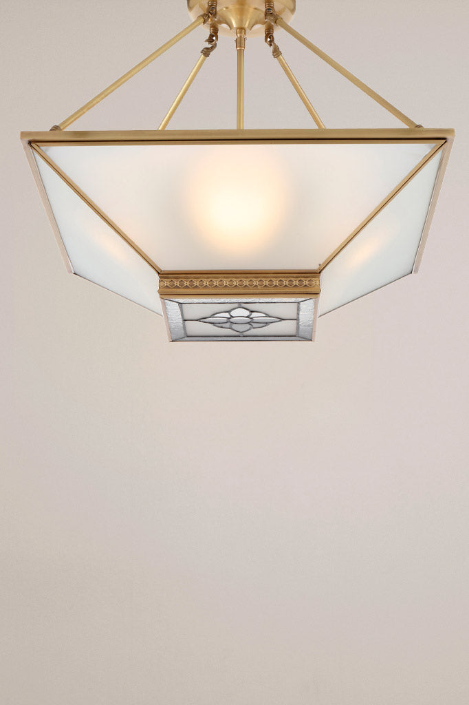  The Clarkson Brass Pendant Light, featuring a solid brass frame and frosted glass panels, captured from a bottom angle.