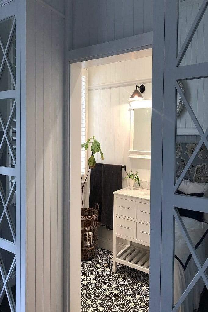 cone wall light in rustic bathroom