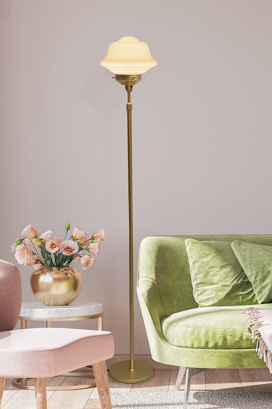 Gold/Brass Floorlamp with small opal Chelsea schoolhouse shade in a pink and green seating area. 