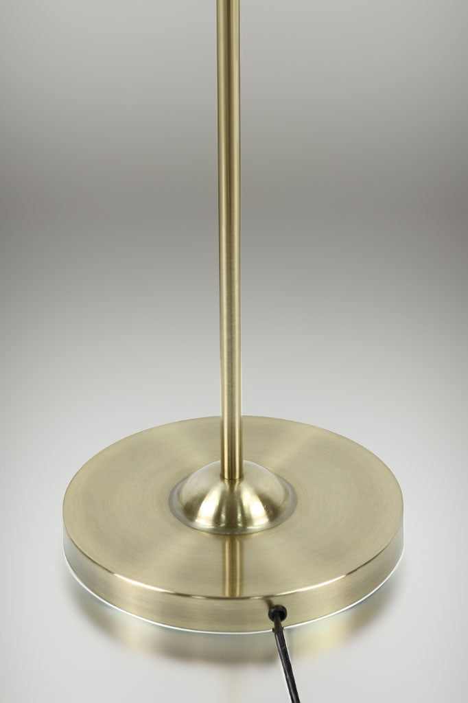 close up of the base of the gold/brass floor lamp