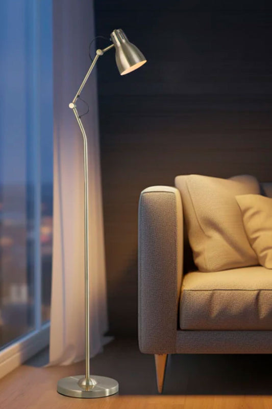 Antique brass floor lamp next to a sofa in a living room 