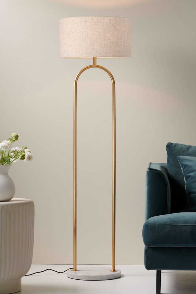 Floor Lamp in Satin Brass with a White Marble base and Flax Linen Shade in a Living Room