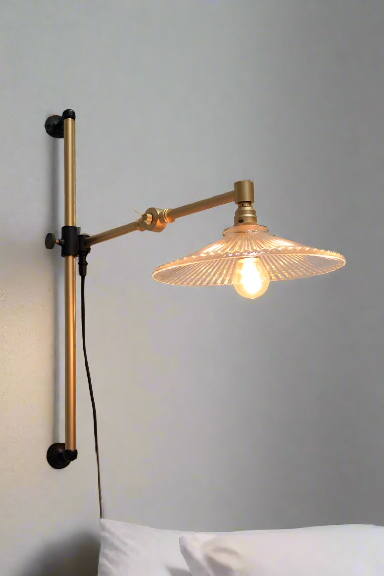 gold brass arm with glass shade