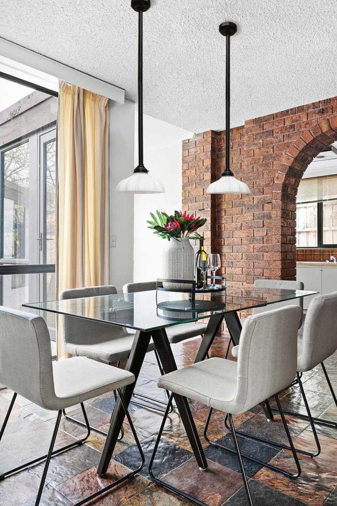 2 pole pendant lights over dining table.