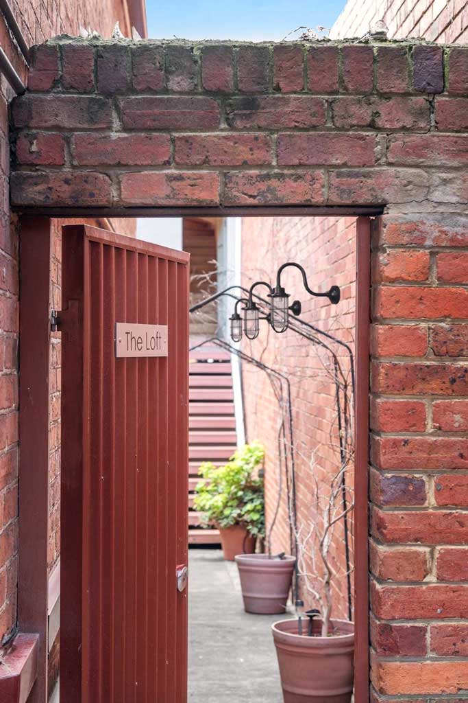 Three outdoor wall lights mounted in brick wall