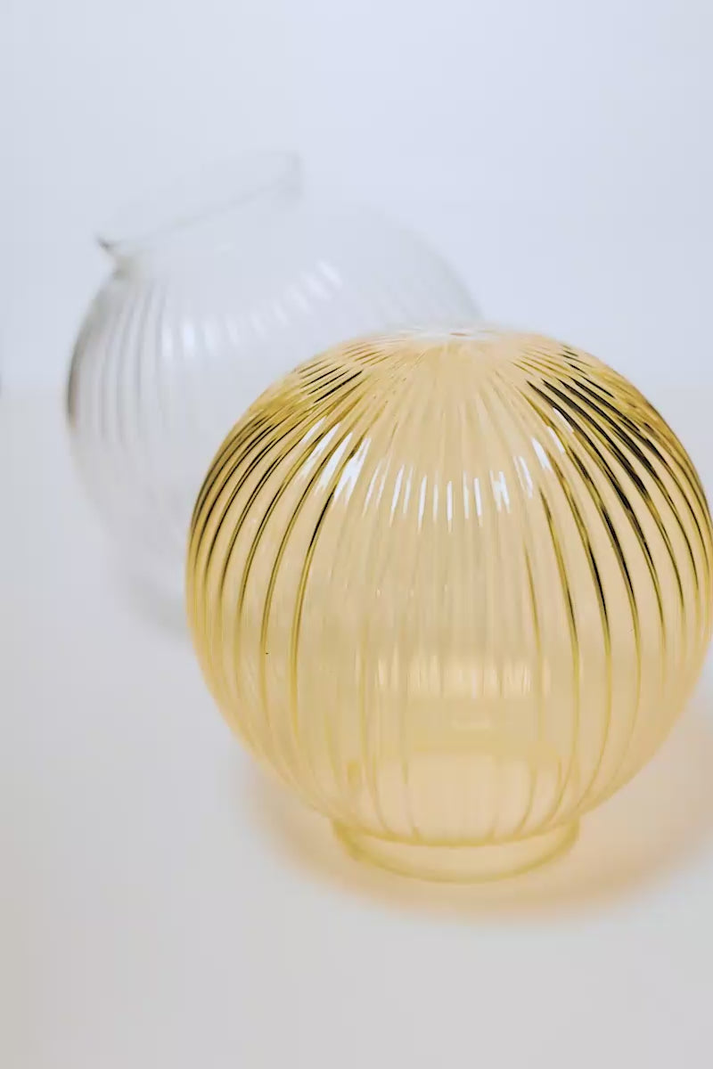 Video showcasing the reeded glass ball shades in clear and amber.