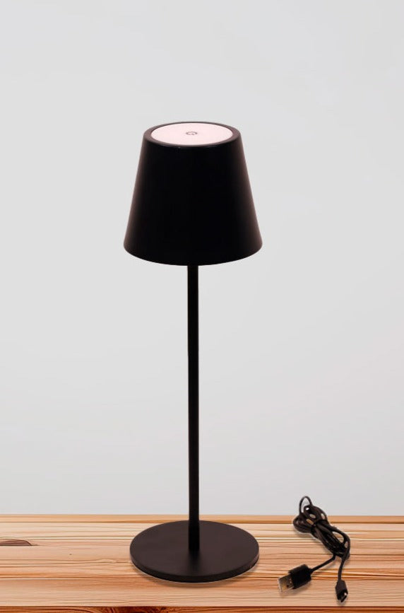 Black LED table lamp over a  table with USB charger