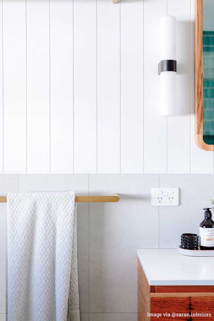 Vanity light next to a mirror in a bathroom