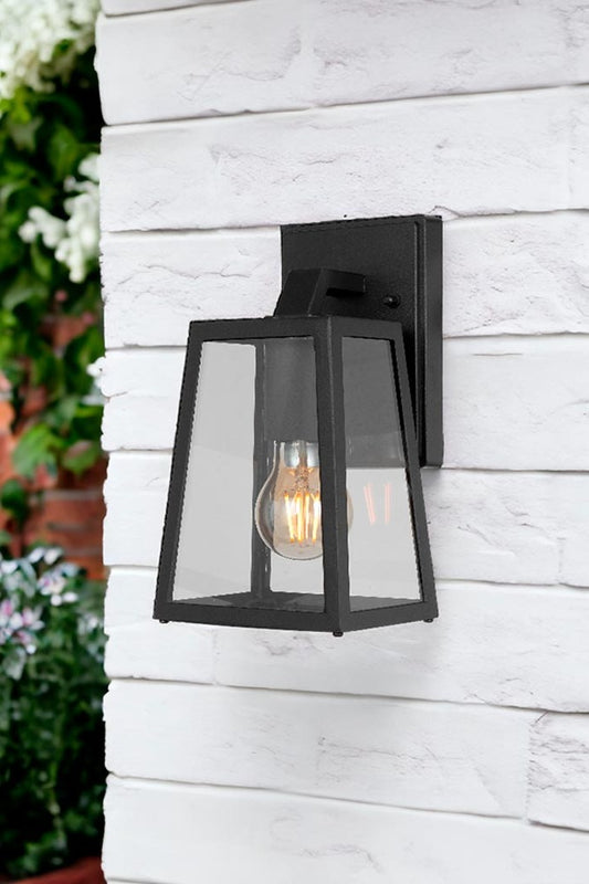 Black small wall lamp illuminating outdoor space