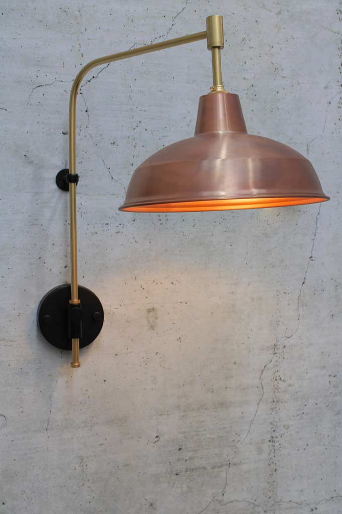 Warehouse Wing Arm Wall Lamp with gold/brass arm and copper shade.