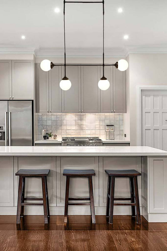 4 light glass ball pendant over kitchen island