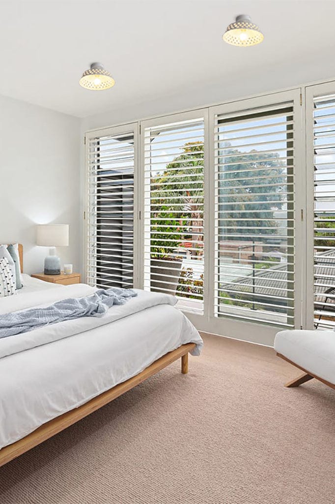 Ceramic flush mount shade in a bedroom 