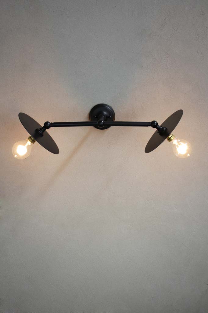 Adjustable black steel wall light with small black discs