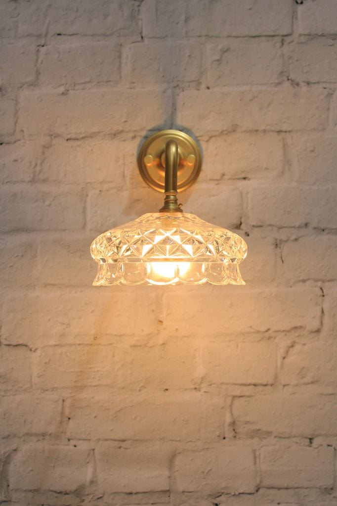 Gold/brass wall light with cut glass style shade