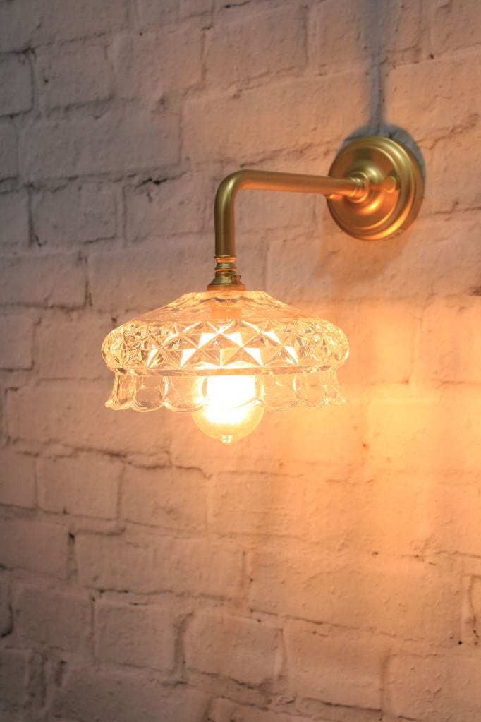 Gold/brass wall light with cut glass style shade