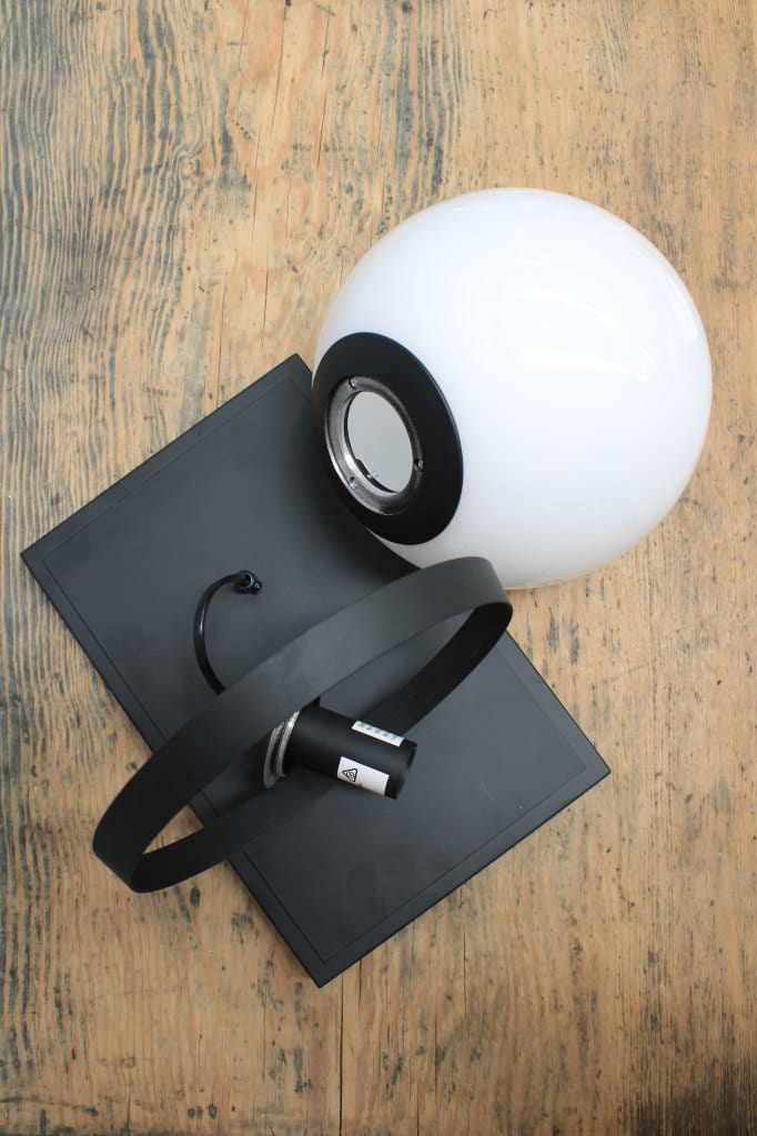 Glass ball wall light with steel mount in black finish