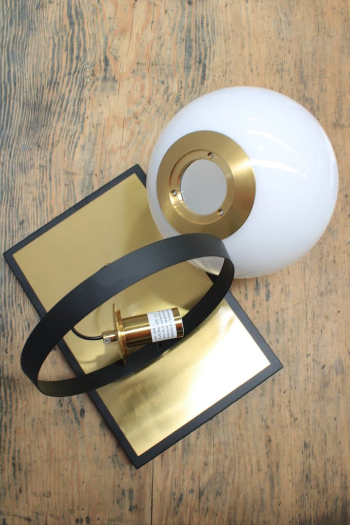 Glass ball wall light with brass mount 