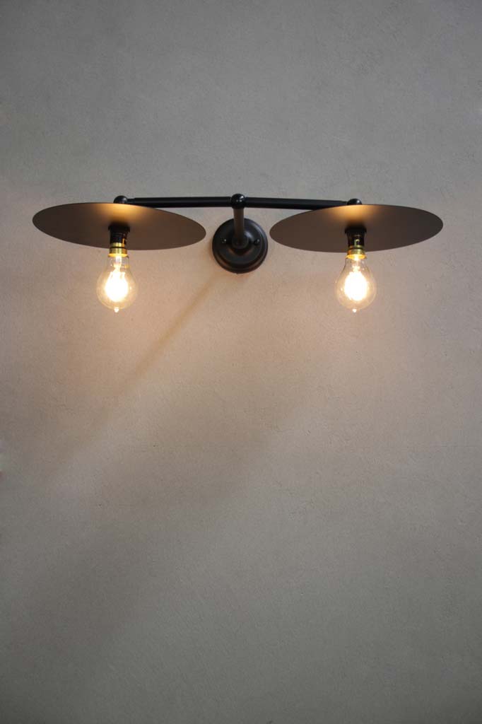 Black double arm wall light with large black discs