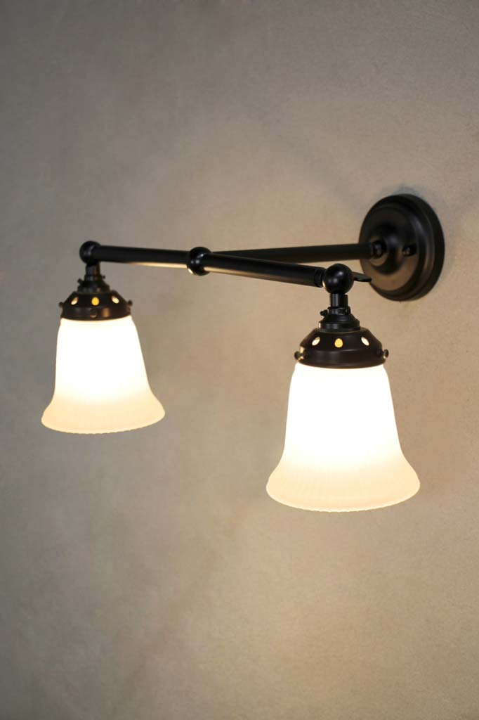 Black double arm wall light with opal glass shades