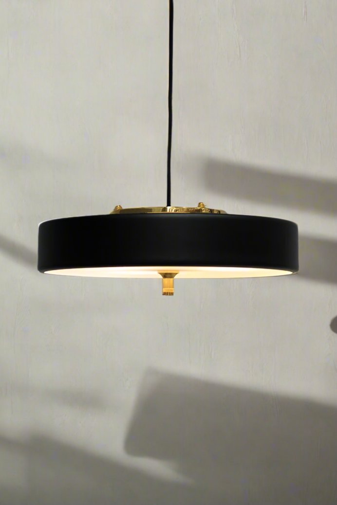 Black pendant light with gold/brass detailing and frosted diffuser