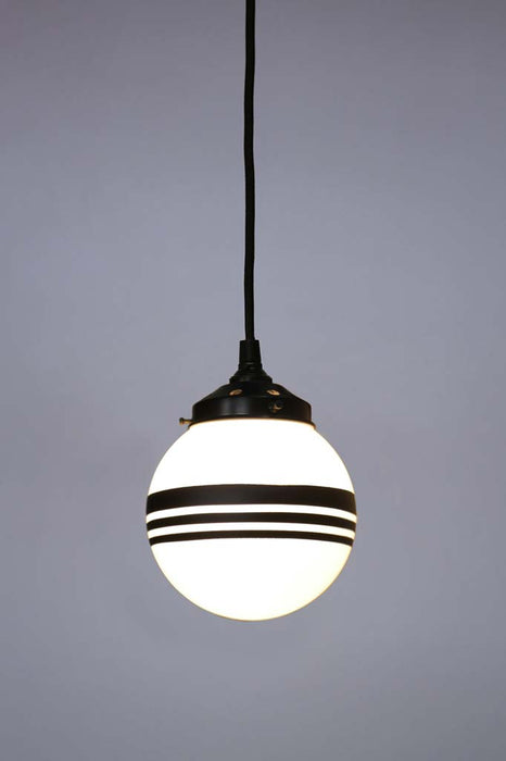 Hand painted opal glass ball pendant light with three stripes hung on black twisted cord